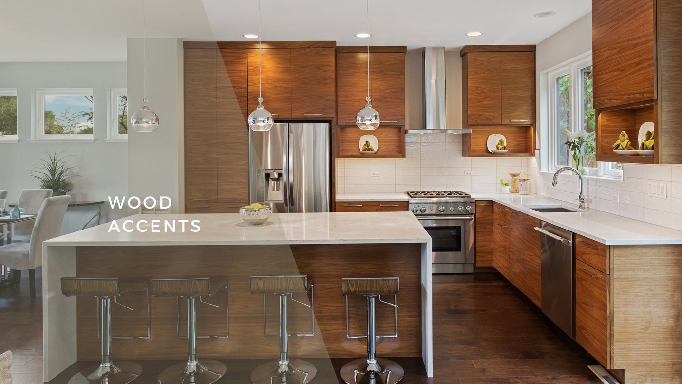 Kitchen with warm wood upper cabinets, a white island and stainless appliances