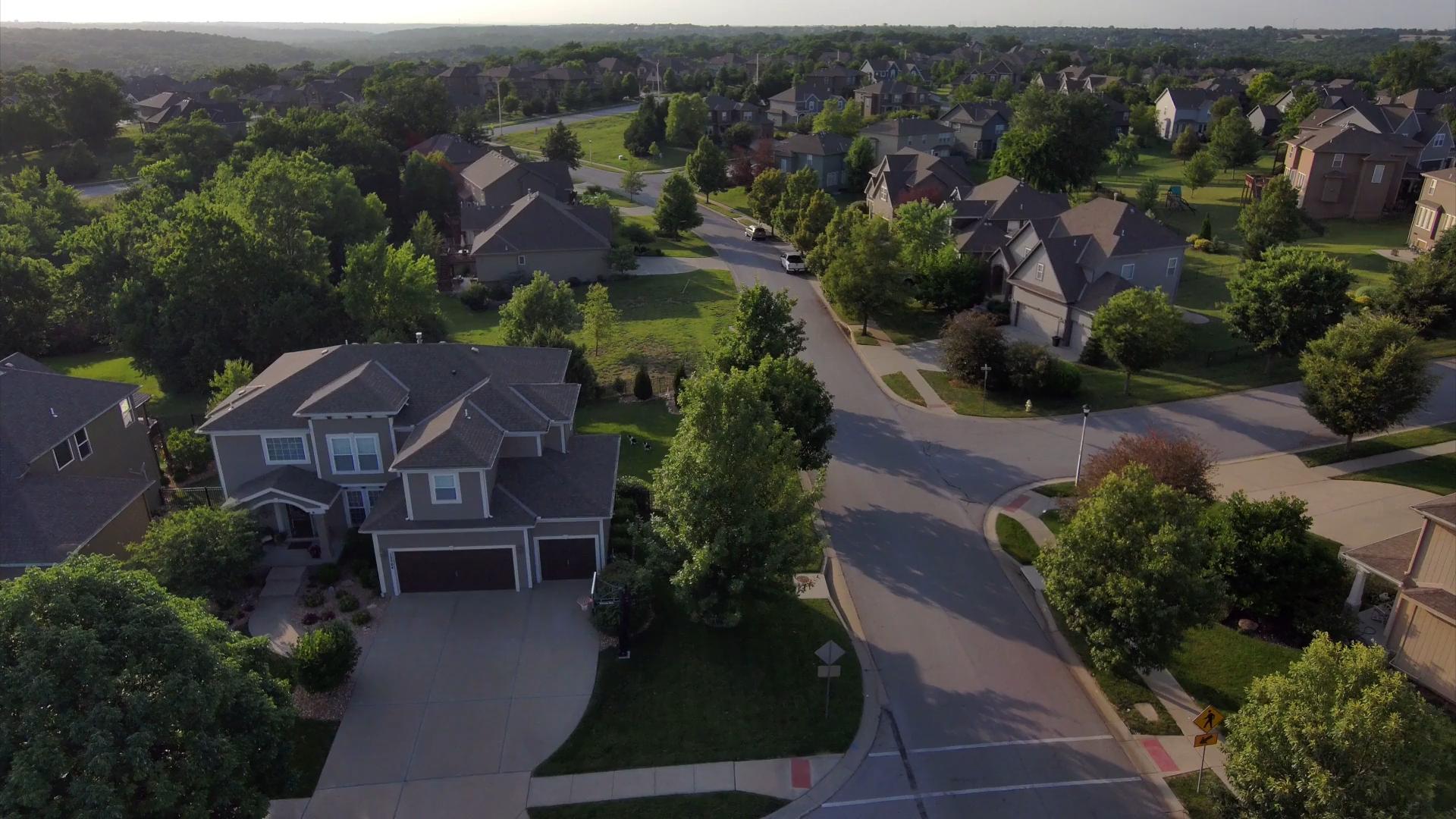 Aerial view of newly built homes along a curving street