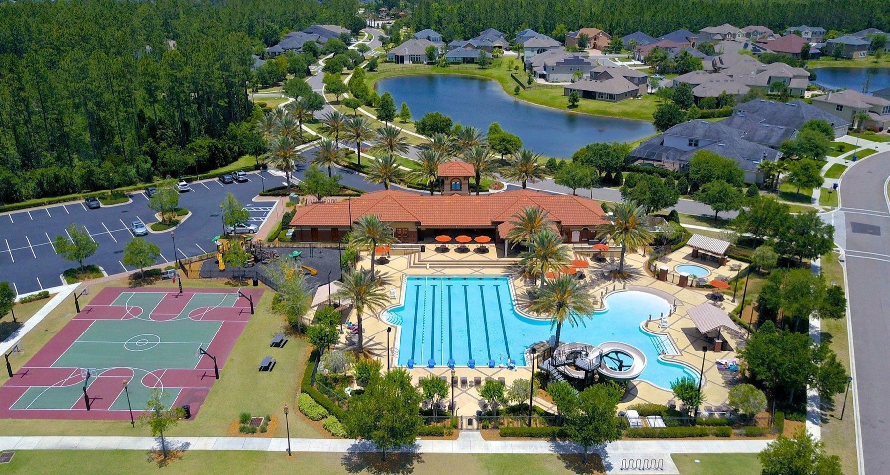 Aerial view of the amenity center, pool and lake in a St Johns County community