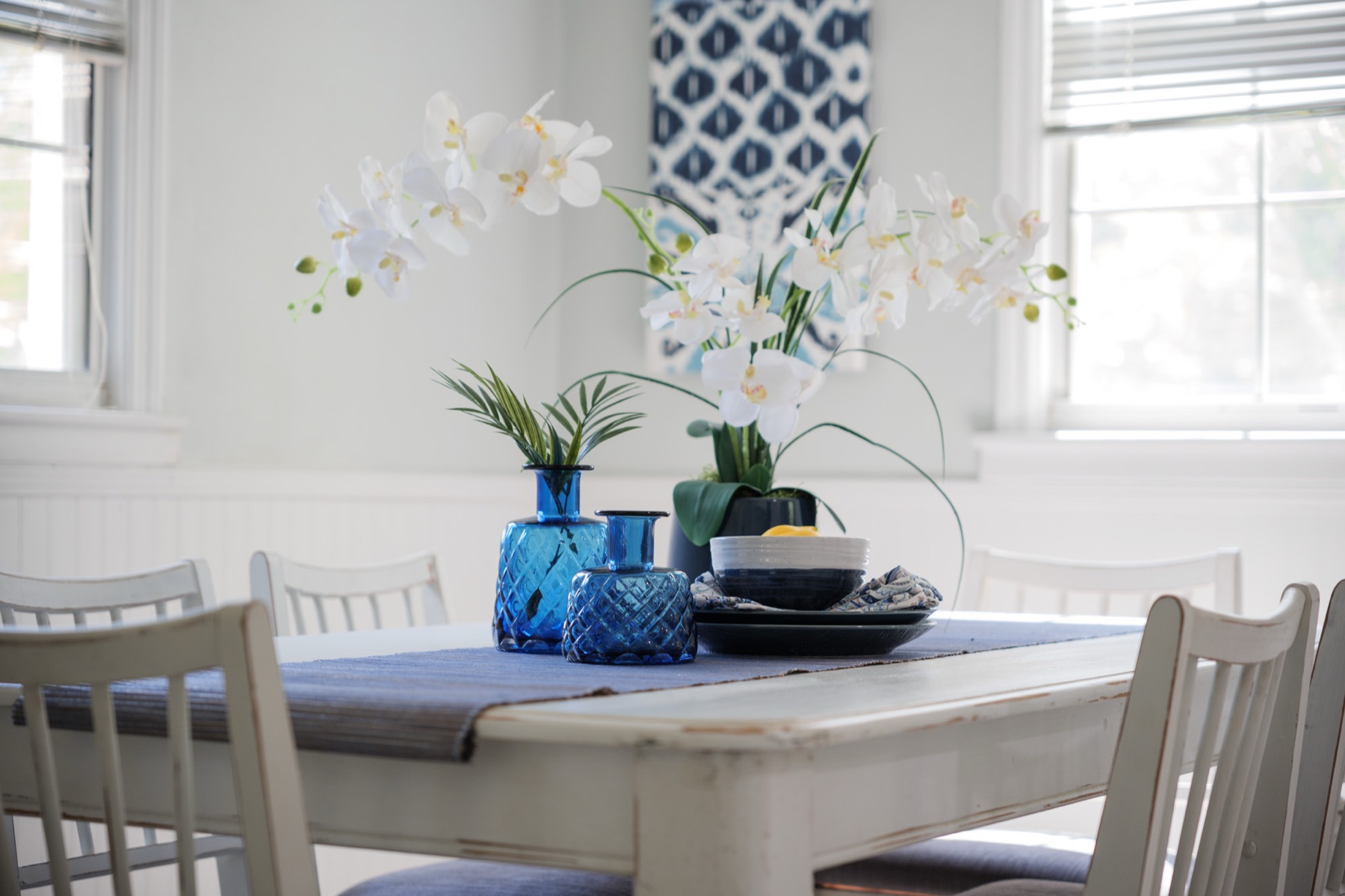 A staged condo kitchen and dining area, freshly painted